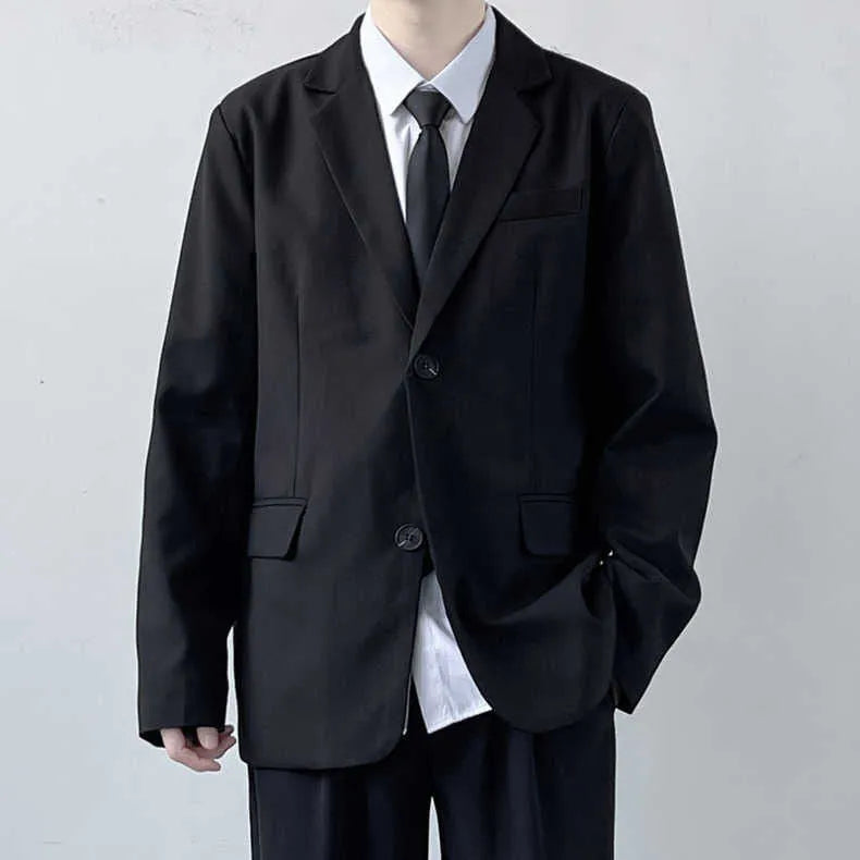 Plus size men in a navy college style suit set with white shirt and tie, showing loose fit.