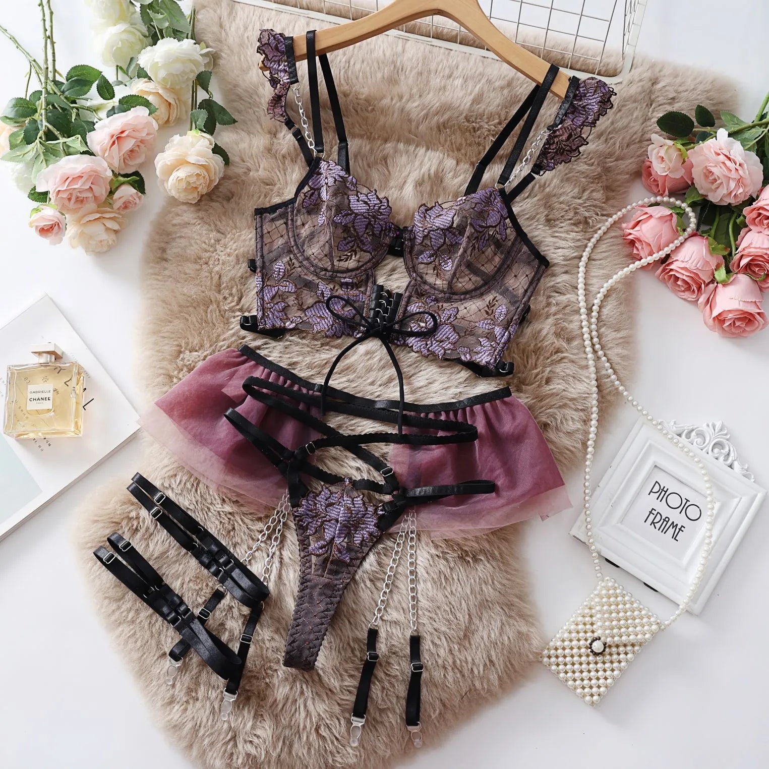 Light blue women's lace push-up bra and matching pants set on a hanger.