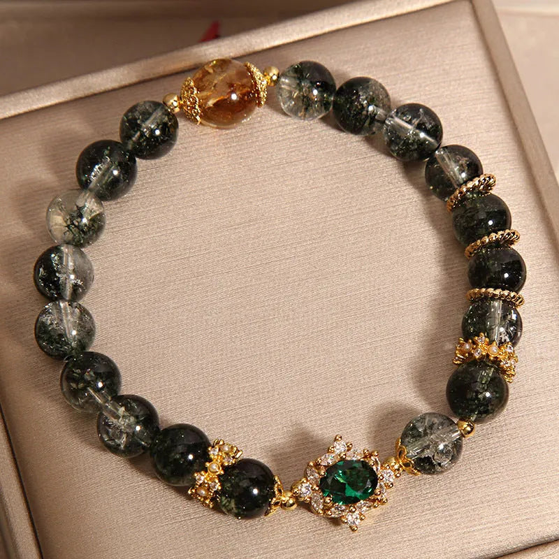 Women's crystal bracelet with gold rutilated quartz, green phantom quartz, and ruby quartz gemstones