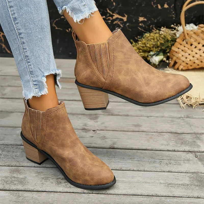 Women's black pointed toe ankle boots with a thick square low heel, made of artificial PU.