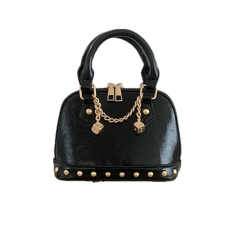Champagne-gold PU shell bag with stitched seams, worn as a shoulder bag against a neutral background