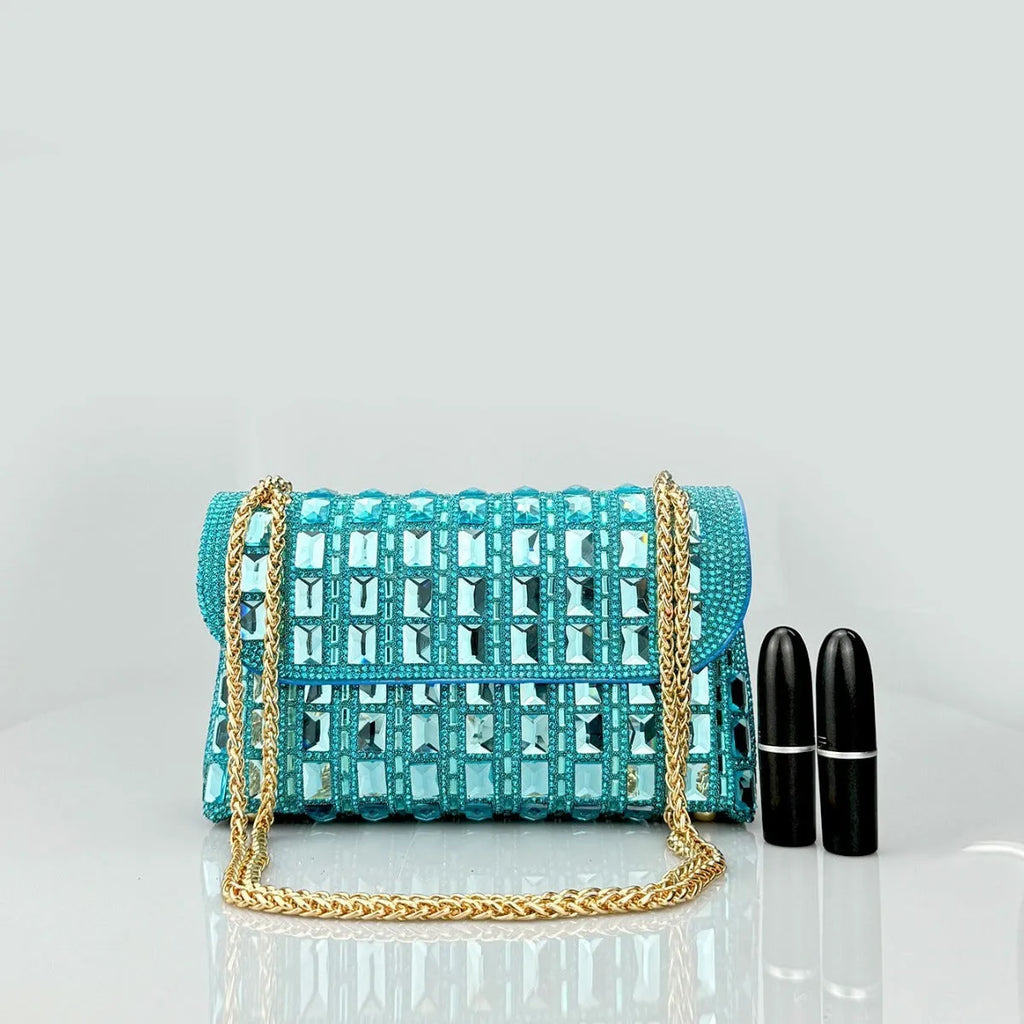 Silver rhinestone chain clutch bag with square shape and internal phone pocket on a table.