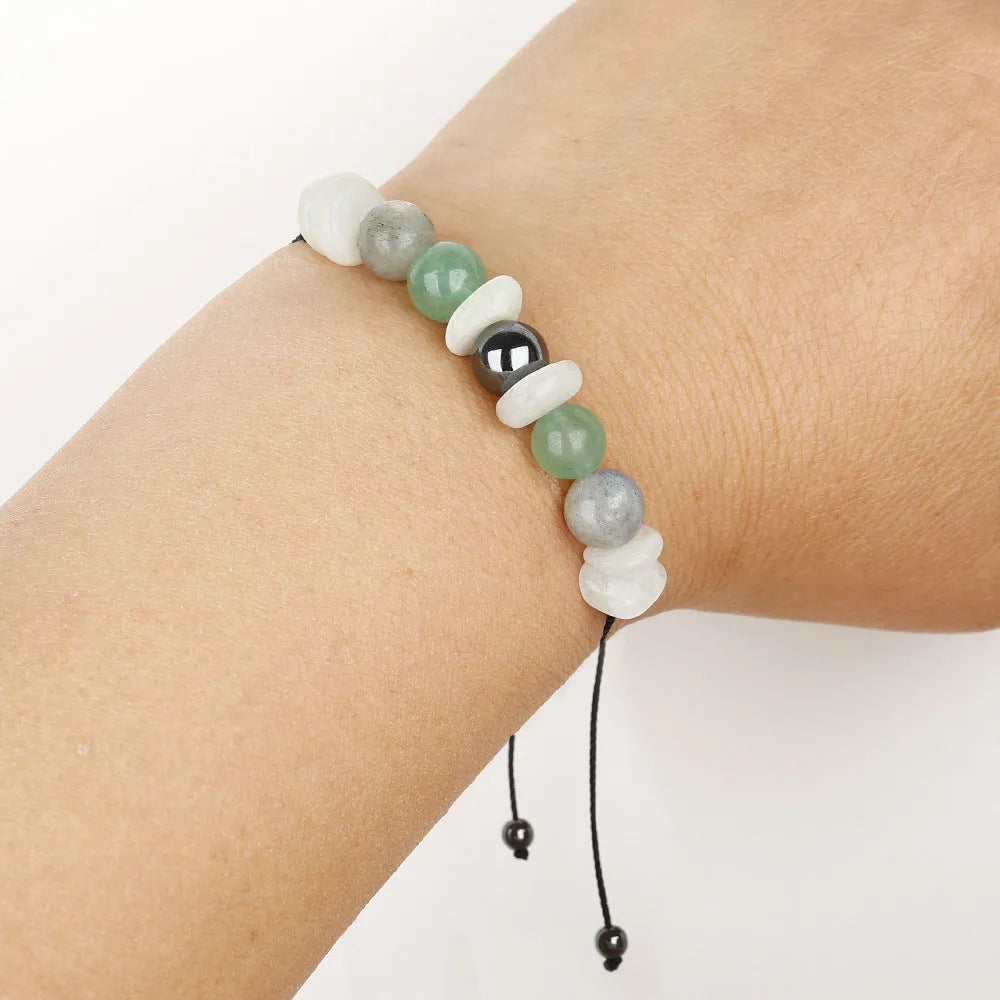 Women's geometric stone bead bracelet in earthy colours on a wrist, showcasing angular bead shapes.