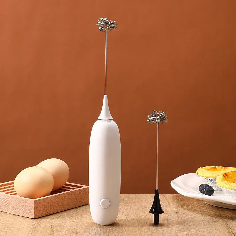 Electric hand-held milk frother blender in black and white colour options on a kitchen counter.