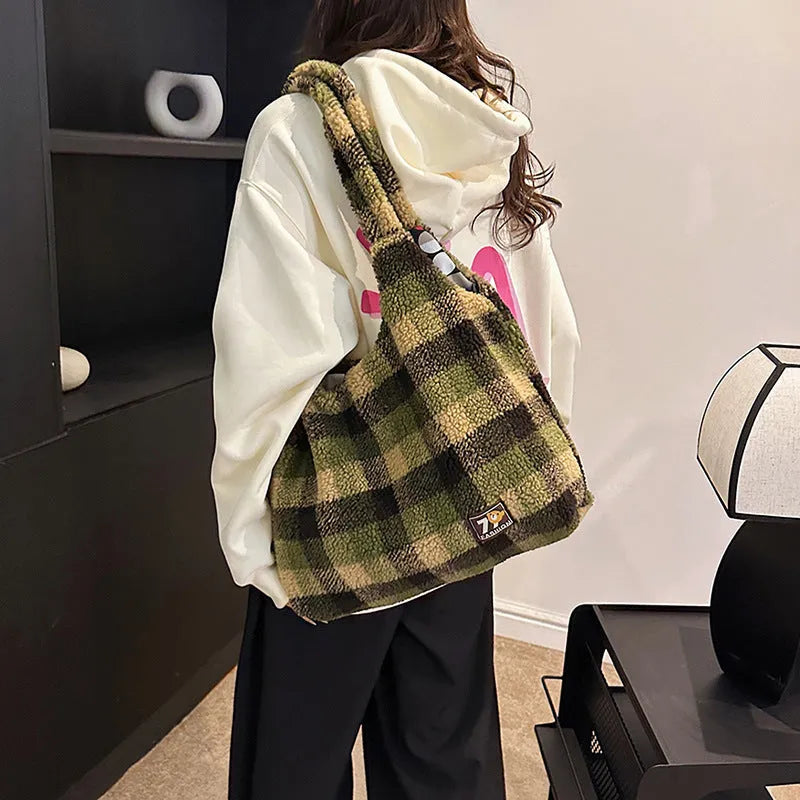 Women's plaid crossbody tote bag in soft plush fabric showing horizontal square shape and strapless shoulder strap