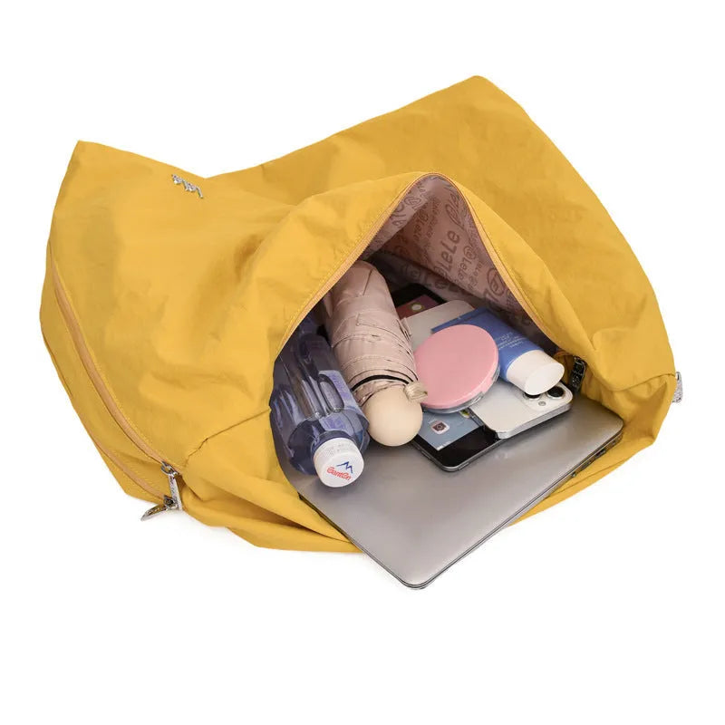Women's heart-shaped nylon underarm bag in black, yellow, khaki, or blue colours showing large capacity design