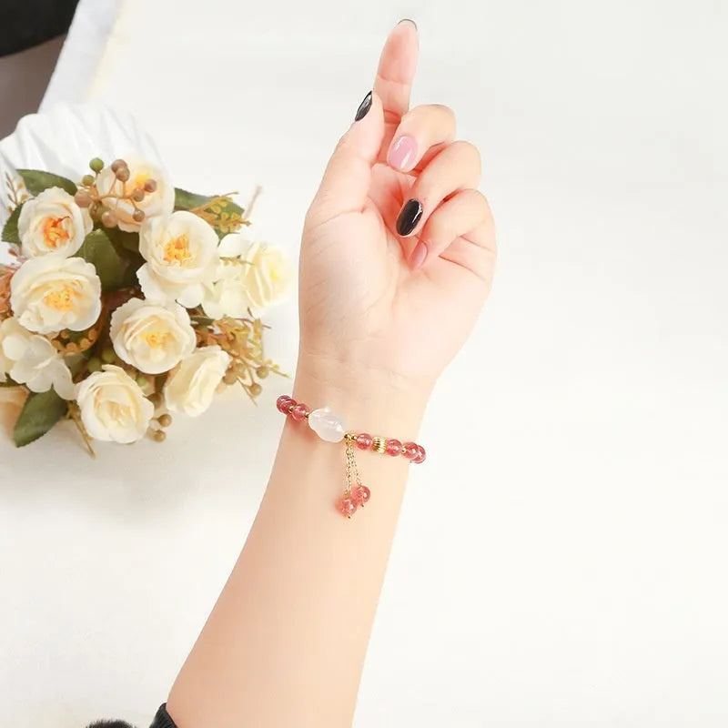 Women's white rabbit bracelet with 6mm round strawberry quartz agate beads in a geometric pattern.