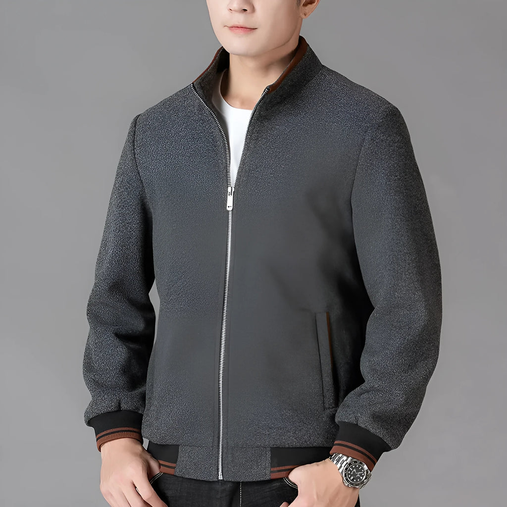 A grey men's sports-style fleece jacket with a stick pocket and long sleeves.