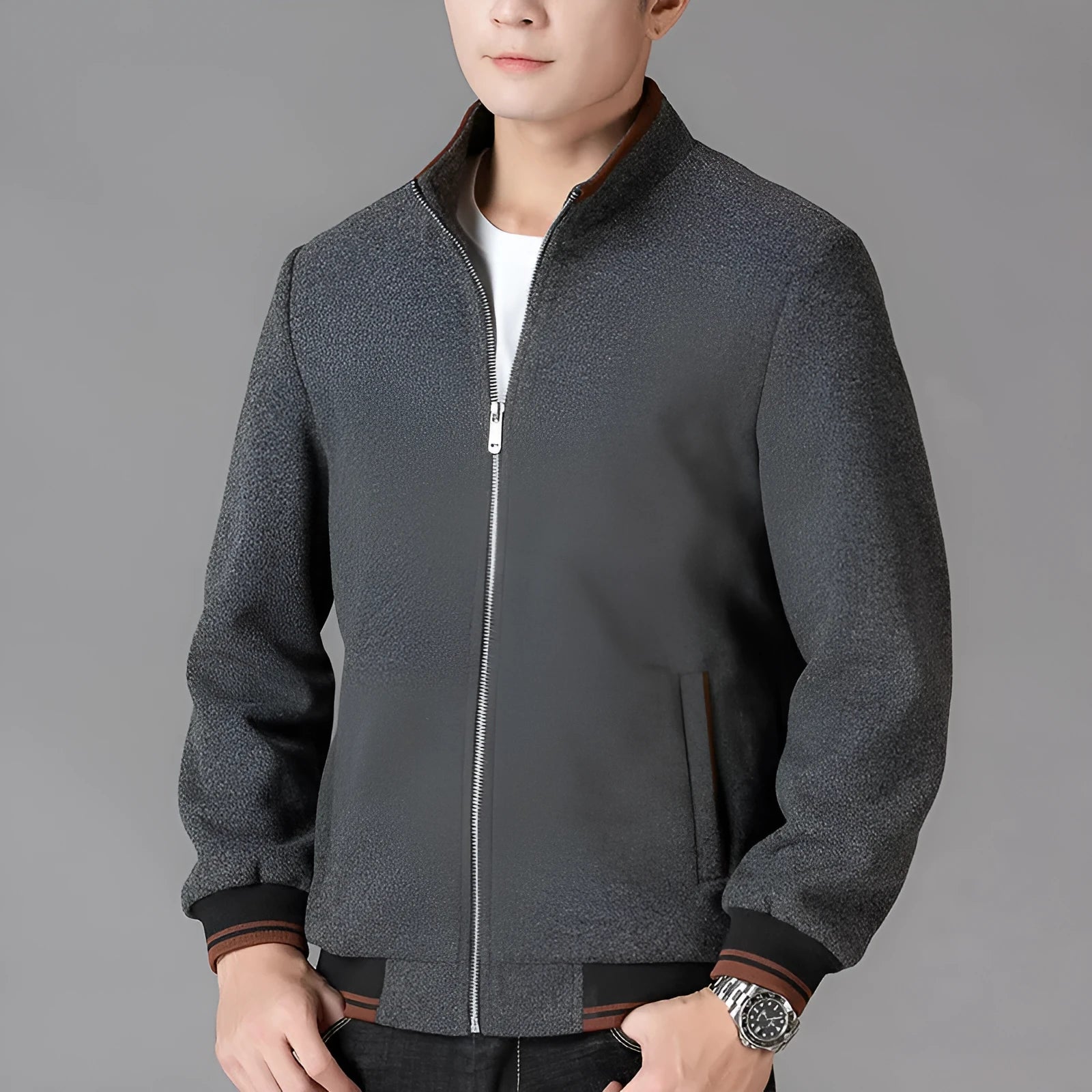 A grey men's sports-style fleece jacket with a stick pocket and long sleeves.
