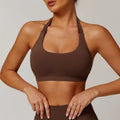 Women's black halter yoga bra with removable chest pad on a mannequin