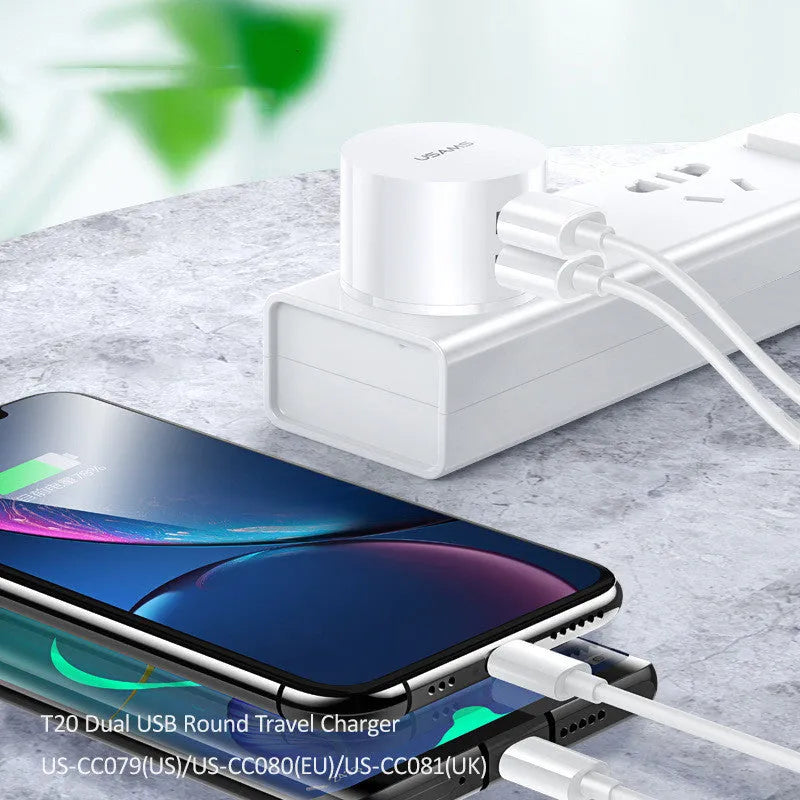 White portable dual USB charger with folding UK, US, and EU plugs showing compact dimensions