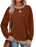 Woman wearing a loose-fitting, long-sleeved striped top with a round neckline in a choice of seven colours.