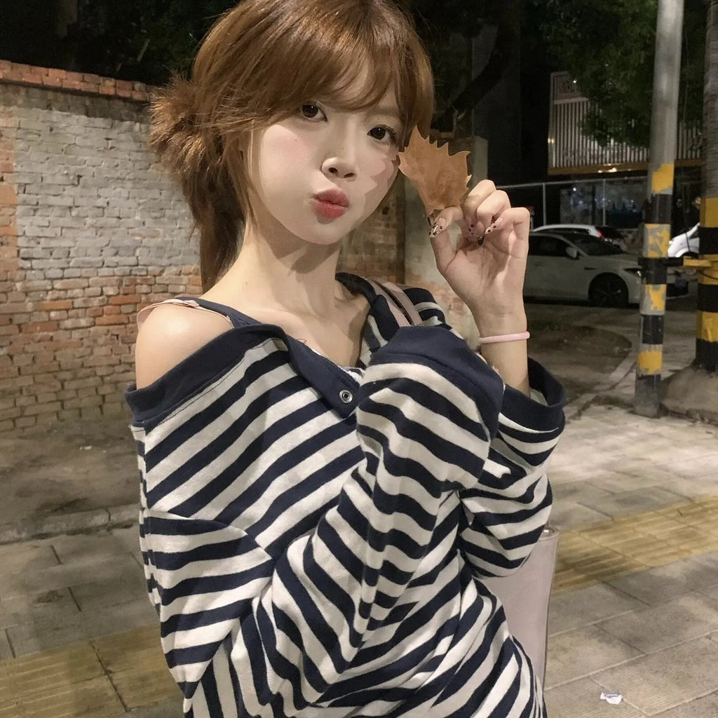 Dark blue women's oversized long sleeve t-shirt with stripes and embroidery detail.
