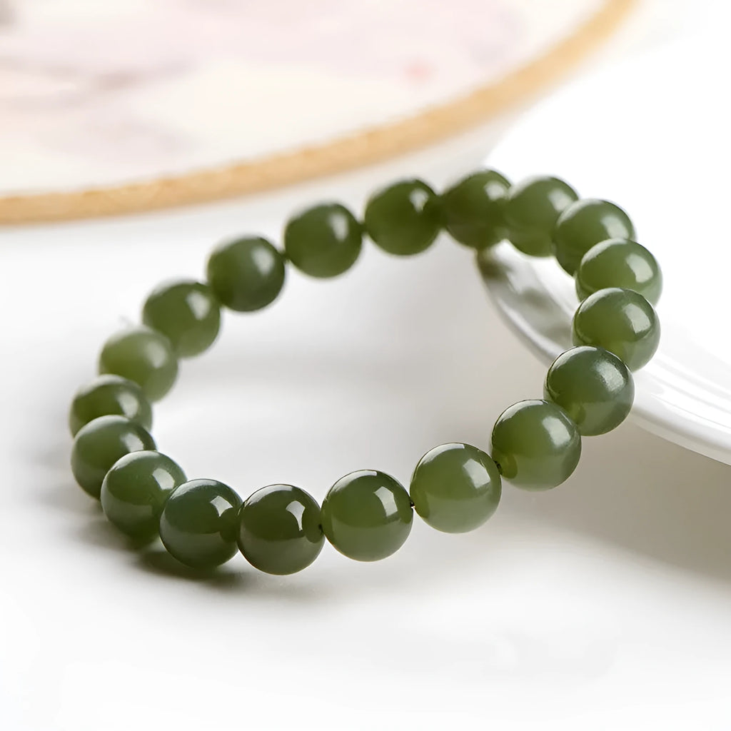 Polished Hetian jade bead bracelet in clear water colours on a wrist, showing bead size options.