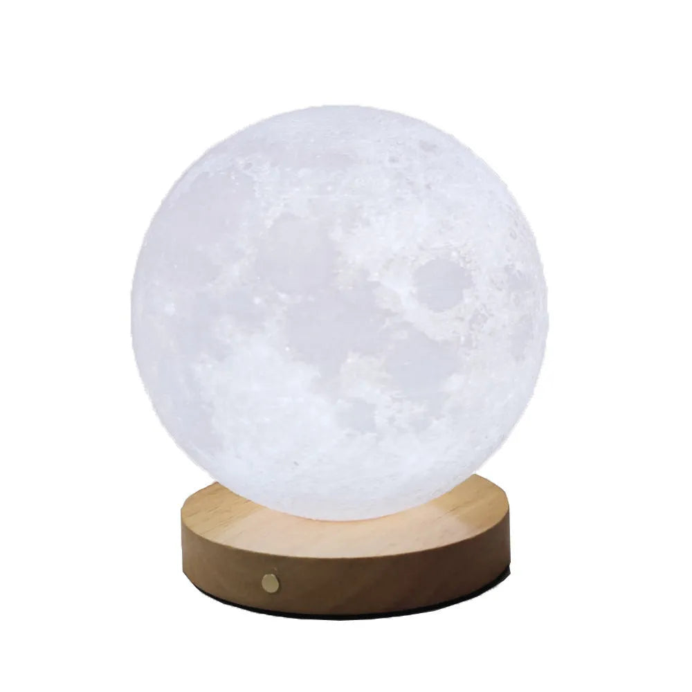Rotating sleeping moon night lamp on wooden base showing three-colour light options.
