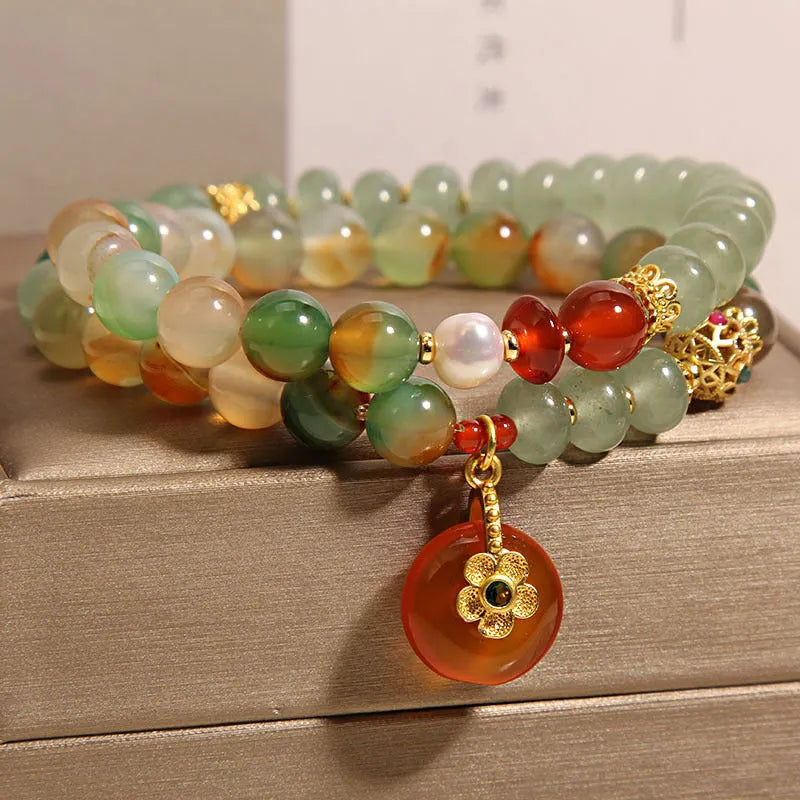 Peacock green agate double ring bracelet for women with safety buckle closure on wrist.