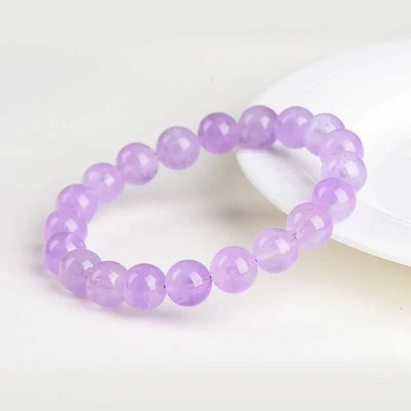 Lavender round amethyst bead bracelet with water ripple texture on a light background.