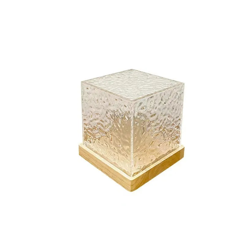 Water ripple crystal table lamp projecting coloured light patterns on wall