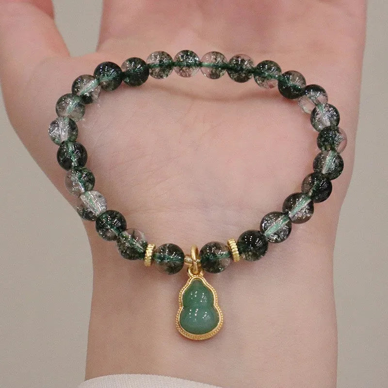 Women's handmade bracelet with citrine, chorite crystal, a green phantom quartz calabash pendant, and pearl accents.