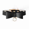 Brown leather cat collar with silver buckle shown adjusted on a table.