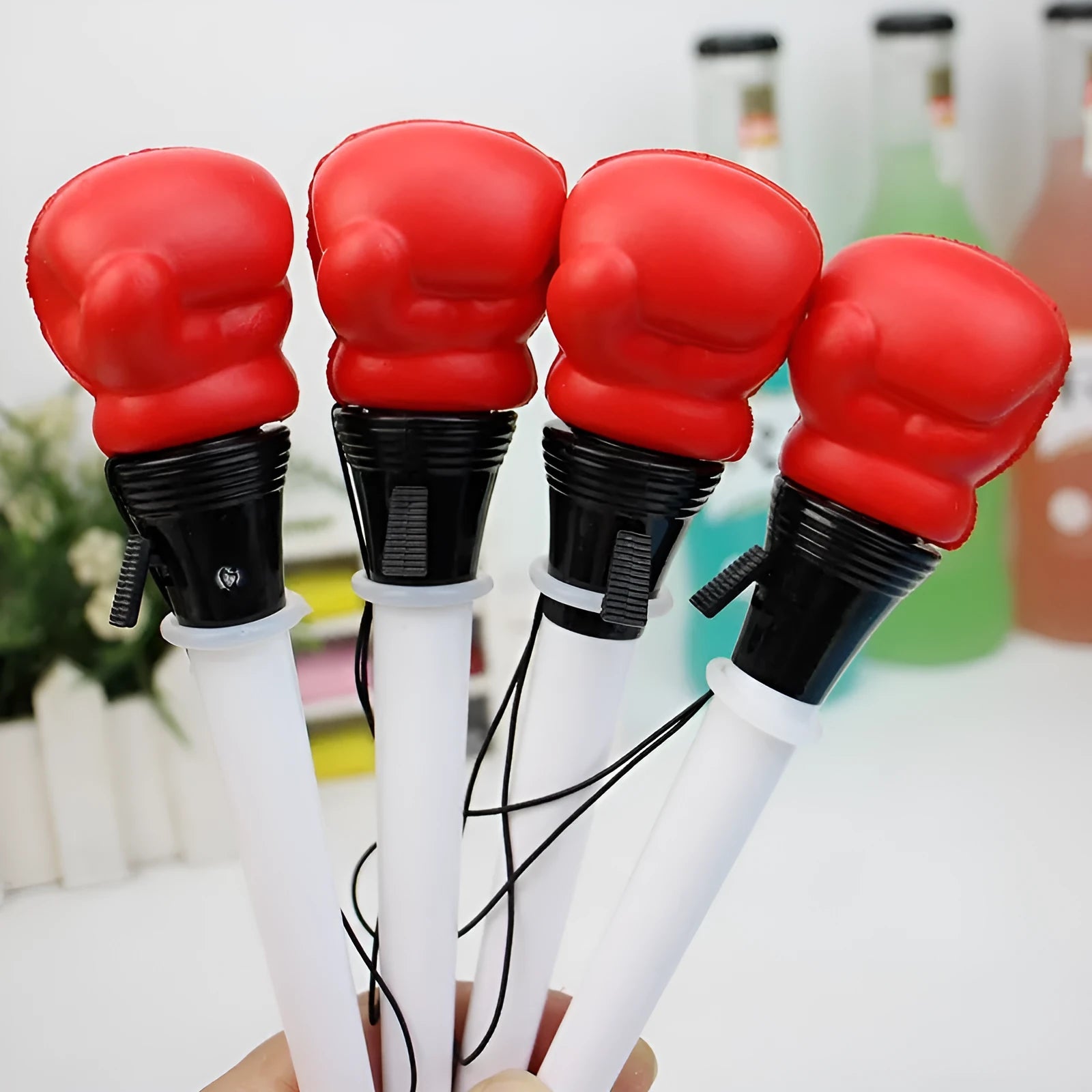 Four black gel pens with pressure relief boxing press ejection mechanisms