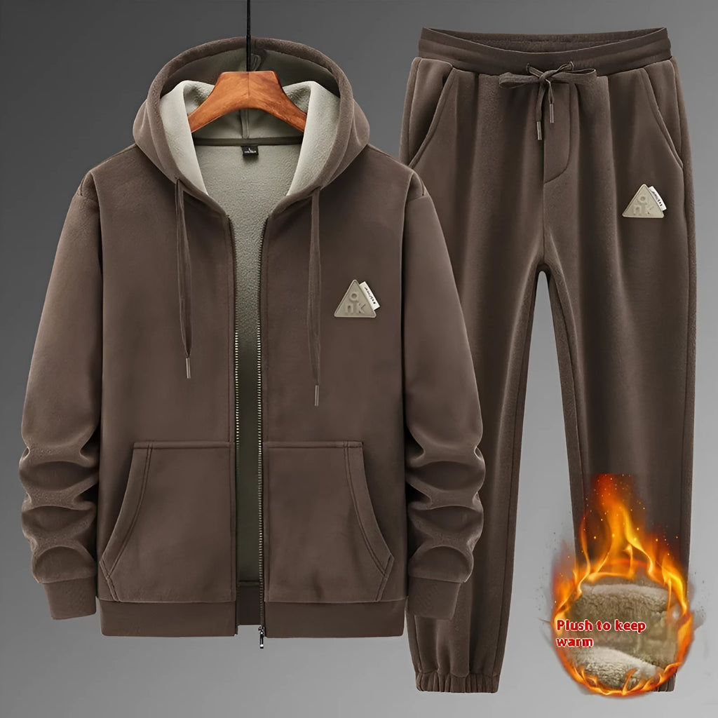 A grey men's casual sports suit featuring a hooded sweater and matching trousers on a hanger.