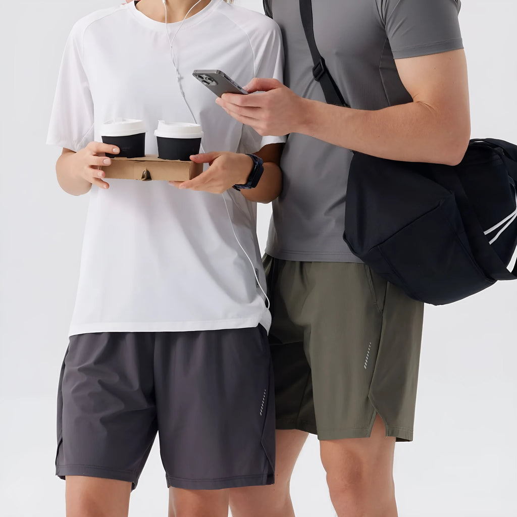 Man wearing black ice silk nylon sports shorts with mid waist and short length design