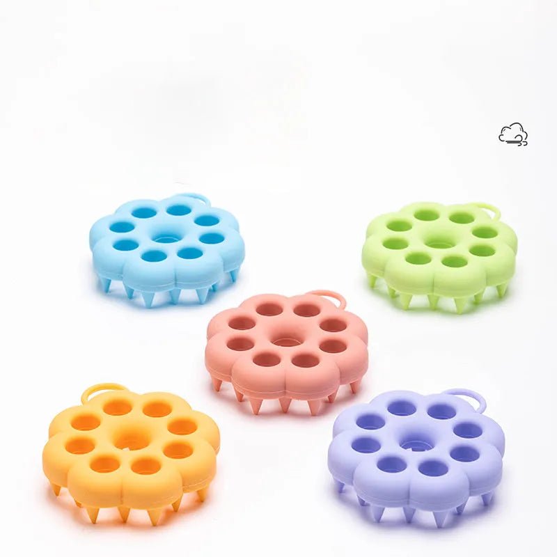 Silicone pet grooming brush with coloured ergonomic handle and flexible massage bristles for dogs and cats.