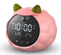 Silicone smart alarm clock with voice control, human body sensor, and luminous display on a bedside table.