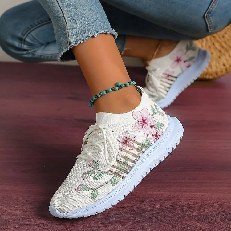 Women's Milky White mesh flyknit running shoes with round toe and rubber sole on a flat surface.