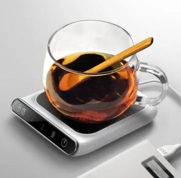 Black USB coffee mug warmer on a desk with a mug, showing three-speed control and tempered glass top.