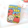 Small decorative iron storage tin box with a colourful printed lid, shown closed.