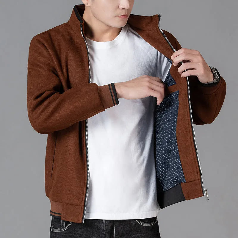 A grey men's sports-style fleece jacket with a stick pocket and long sleeves.