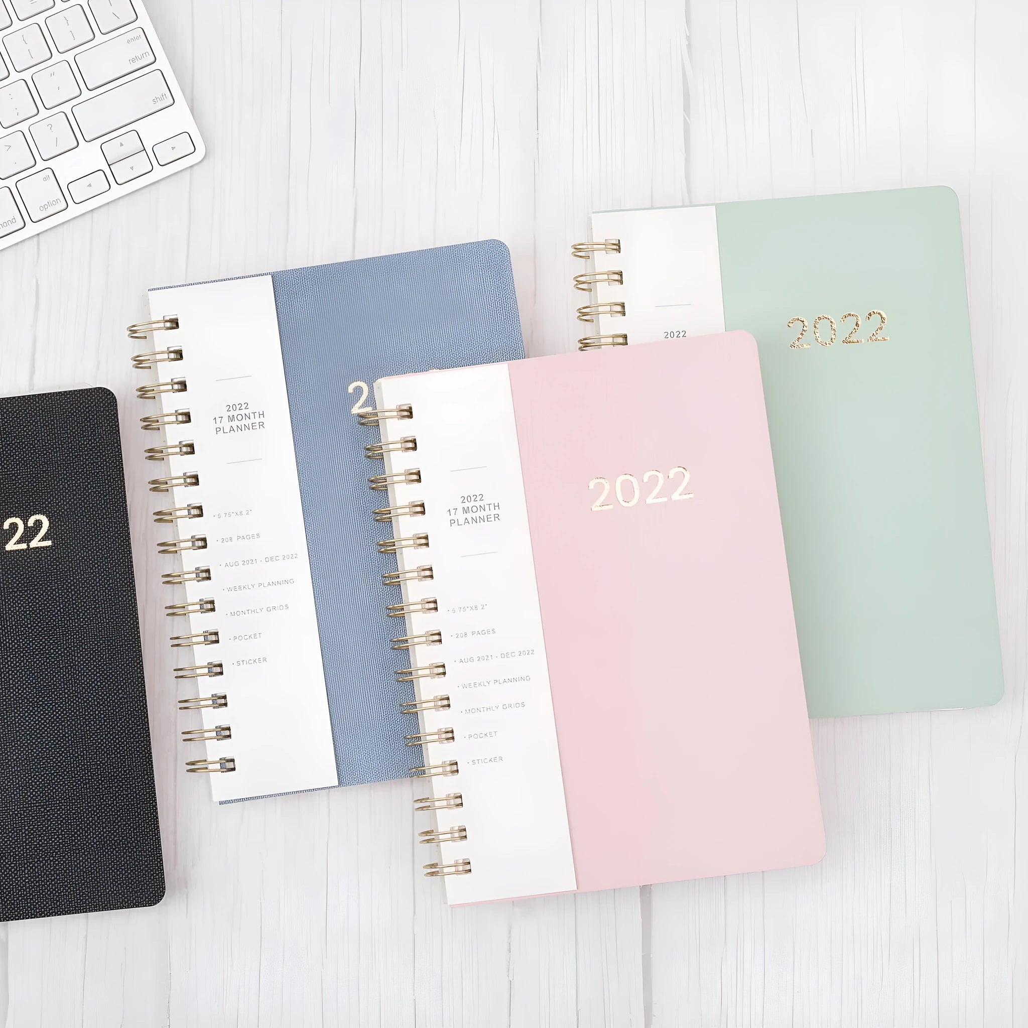 Green 2022 student weekly planner with coil binding, PU leather cover, open to show monthly grid and pockets.