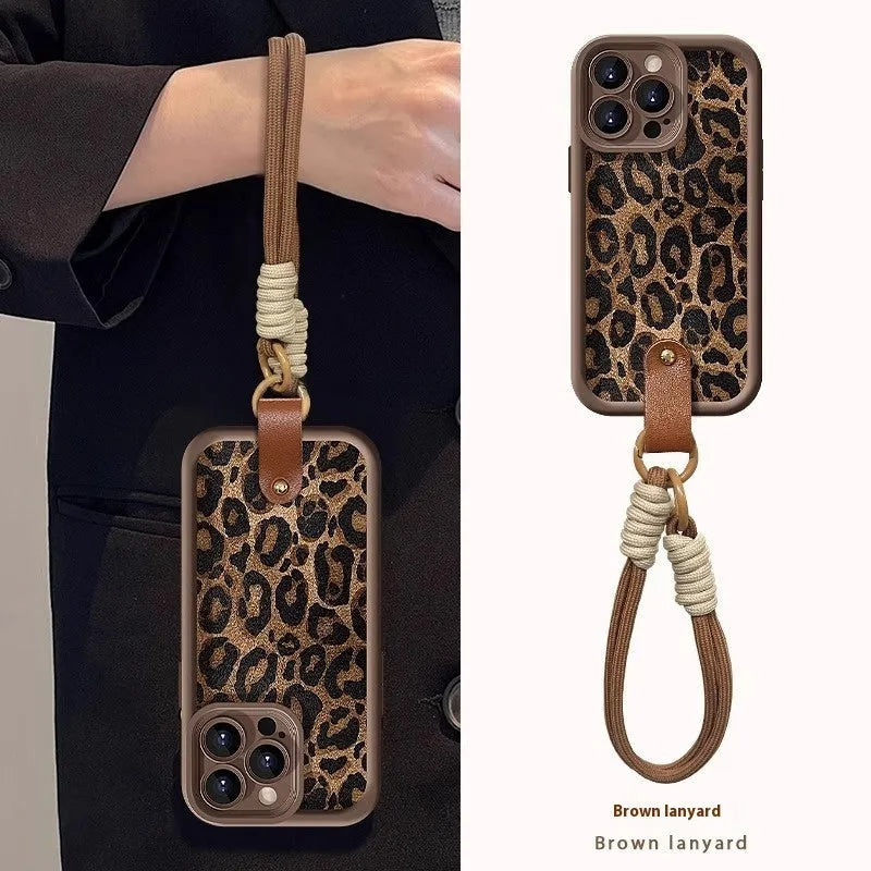 Brown leopard print silicone lanyard phone case for iPhone on a table