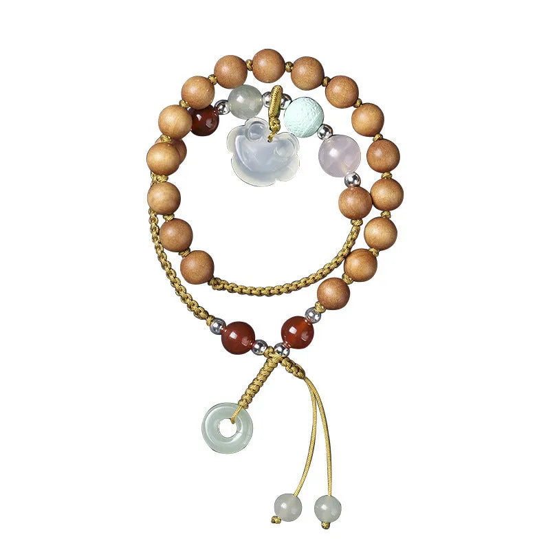 Women's hand-woven ebony double ring bracelet with traditional Ruyi motifs in Xiuyan jade or antique chalcedony