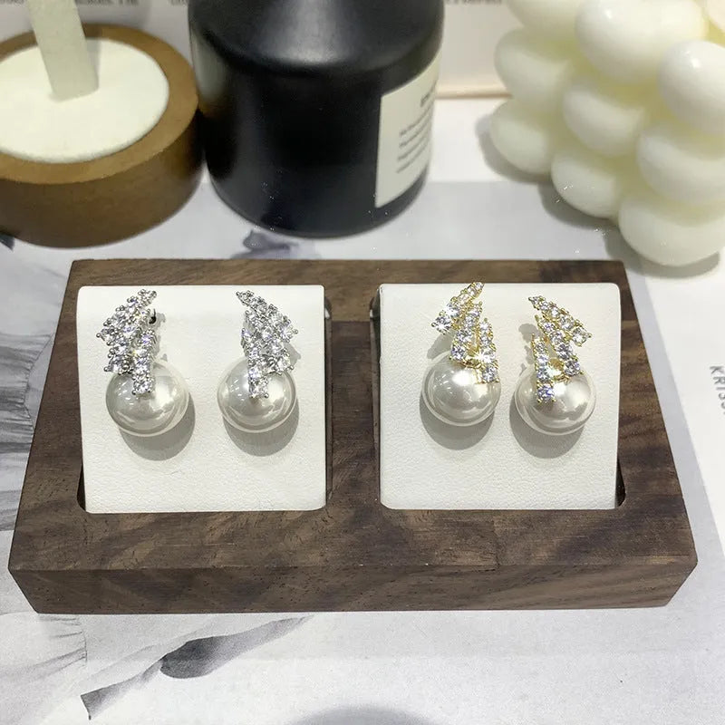 Curved zircon pearl earrings available in golden cats eye stone, golden white pearl, and silver white pearl