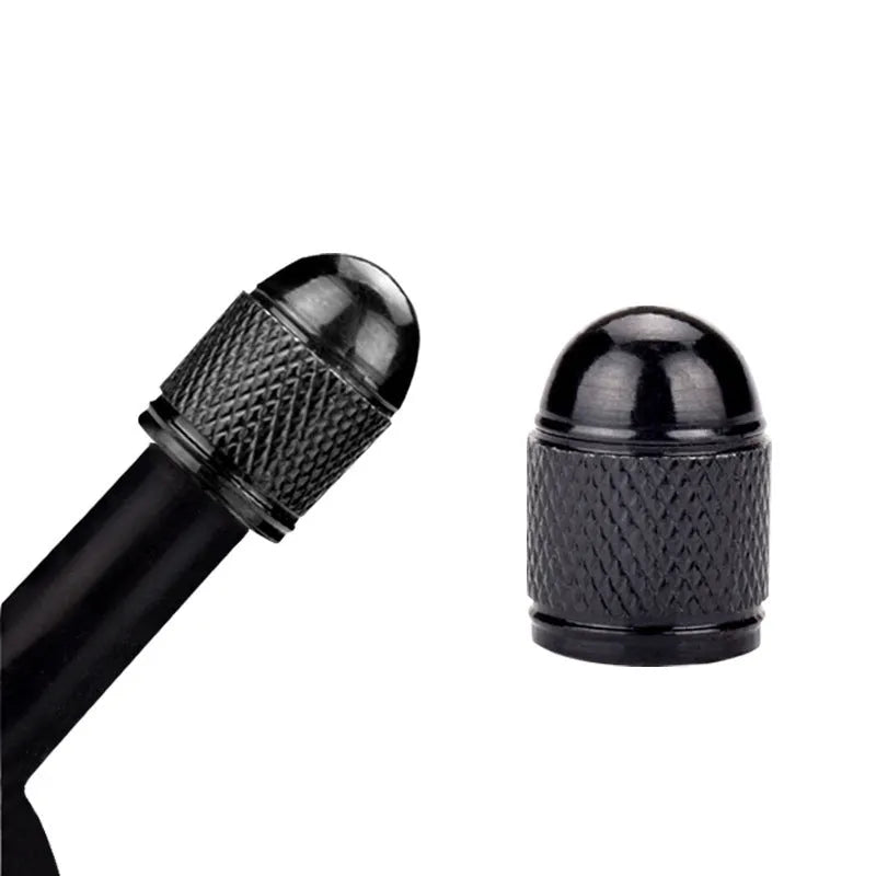 Aluminium mountain bike tyre valve caps in black, blue, gold, red, and silver colours.