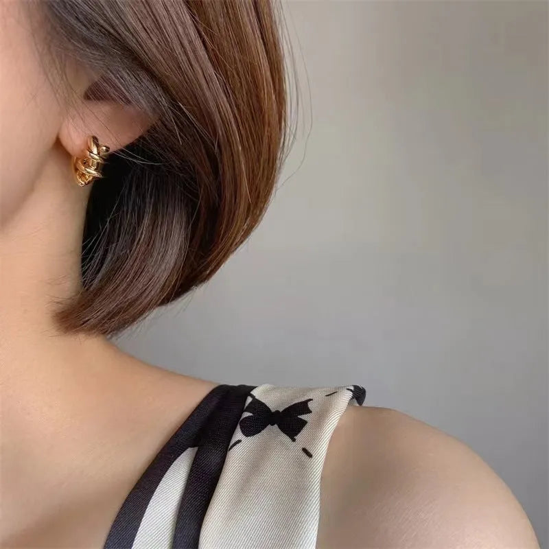 Spiral wound ear clip earrings in frosted geometric shape, copper with gold or silver plating, 1.75cm by 2.16cm.