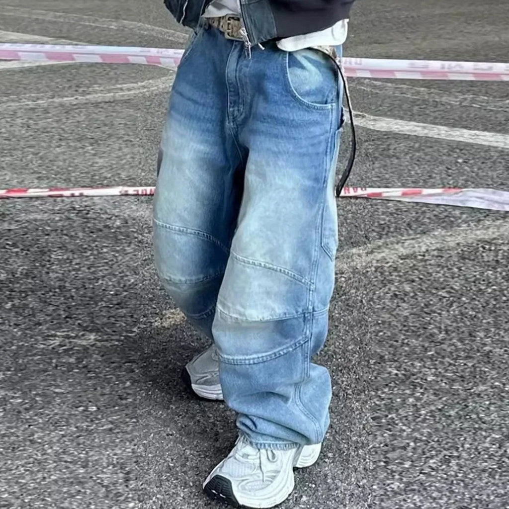 Men's blue white washed denim jeans with baggy cut and straight-leg design showing profile pleating details