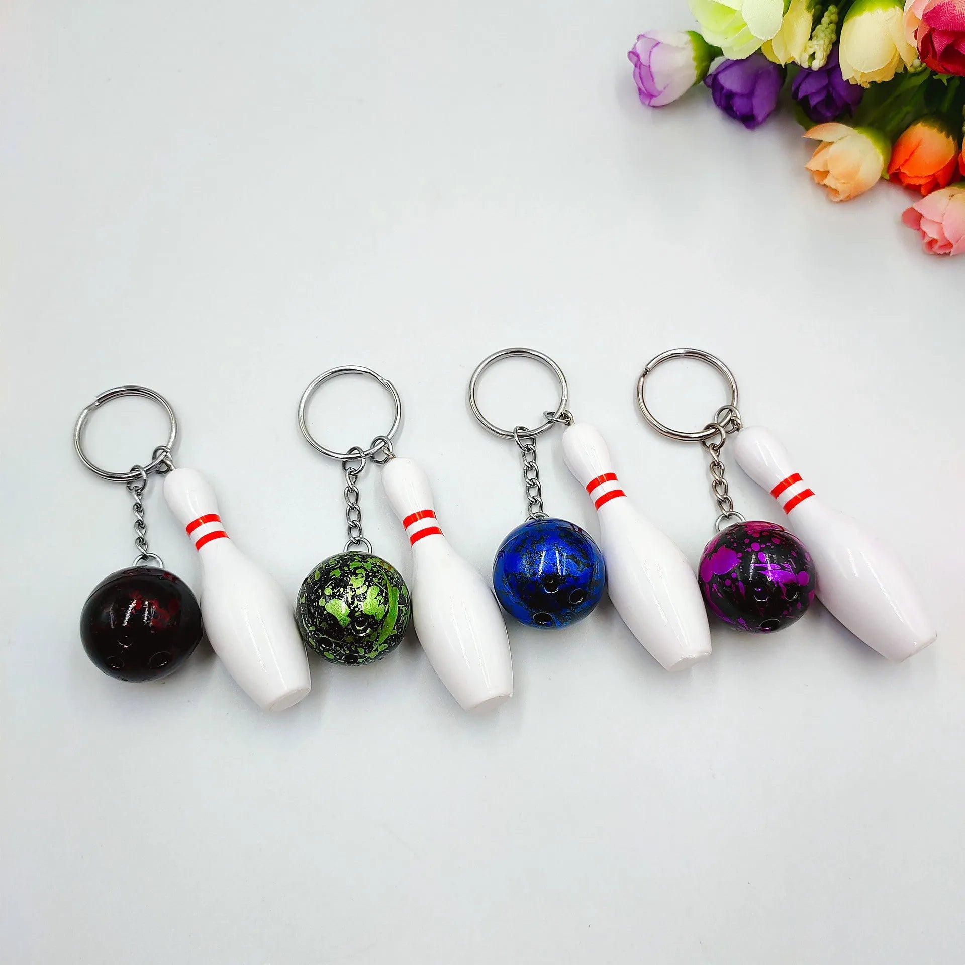 Mini bowling ball keychain pendant in dark red, blue, purple or green colour on keyring