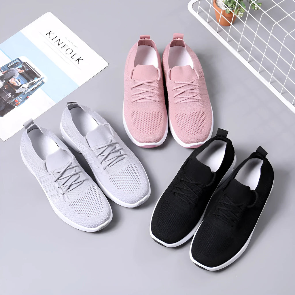 Women's black mesh lace-up sneakers with a round toe and soft sole on a white background.