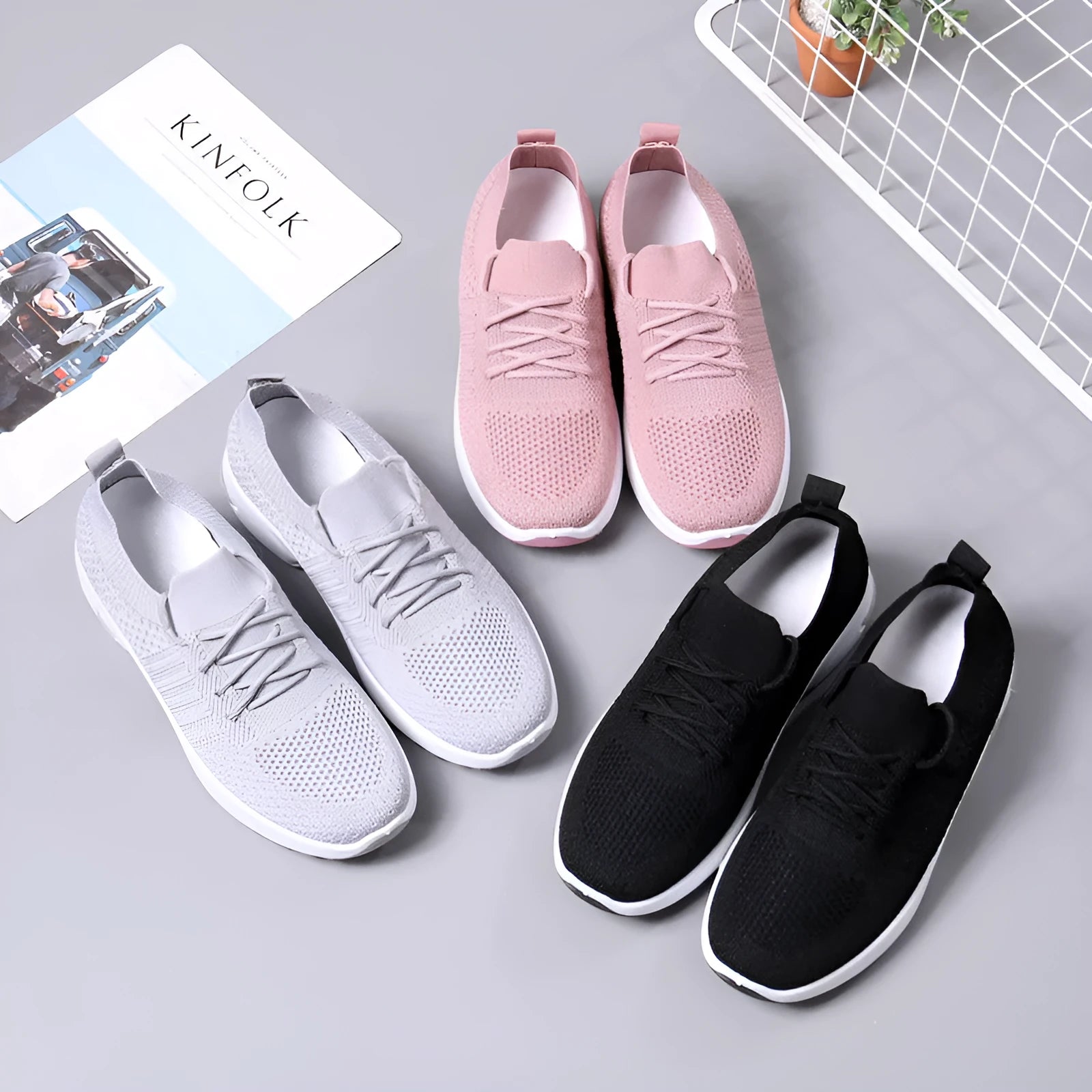 Women's black mesh lace-up sneakers with a round toe and soft sole on a white background.