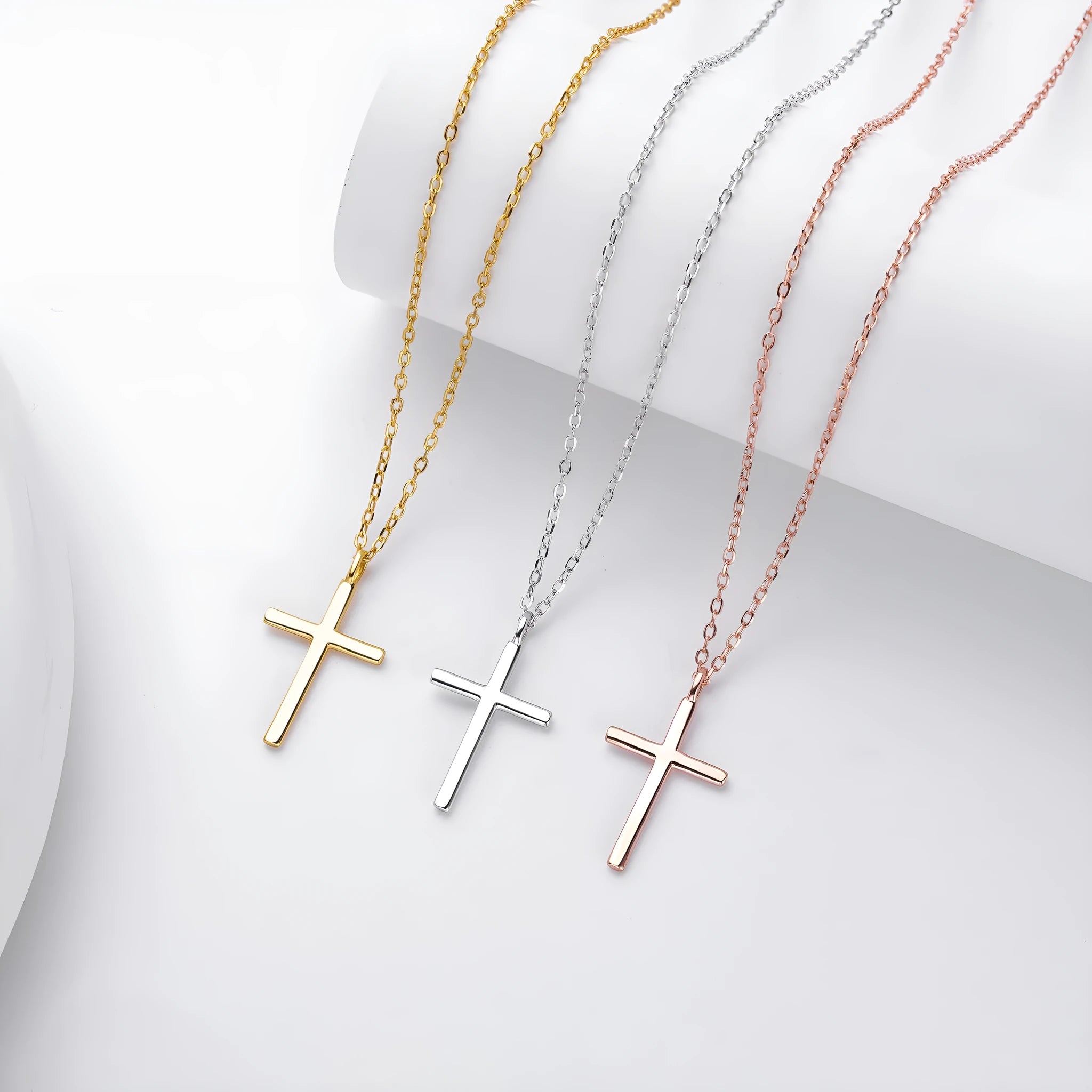 Sterling silver necklace with cross pendant on O-shaped chain showing gold electroplated finish