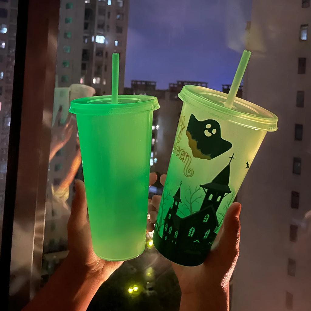 720ml orange Halloween pumpkin plastic cup with luminous straw on a dark background.