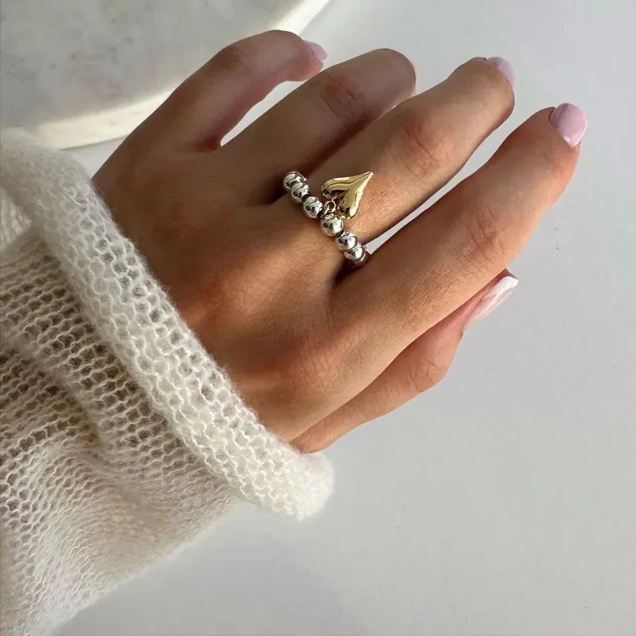 Handmade beaded elastic string love ring with geometric heart design in gold electroplated finish