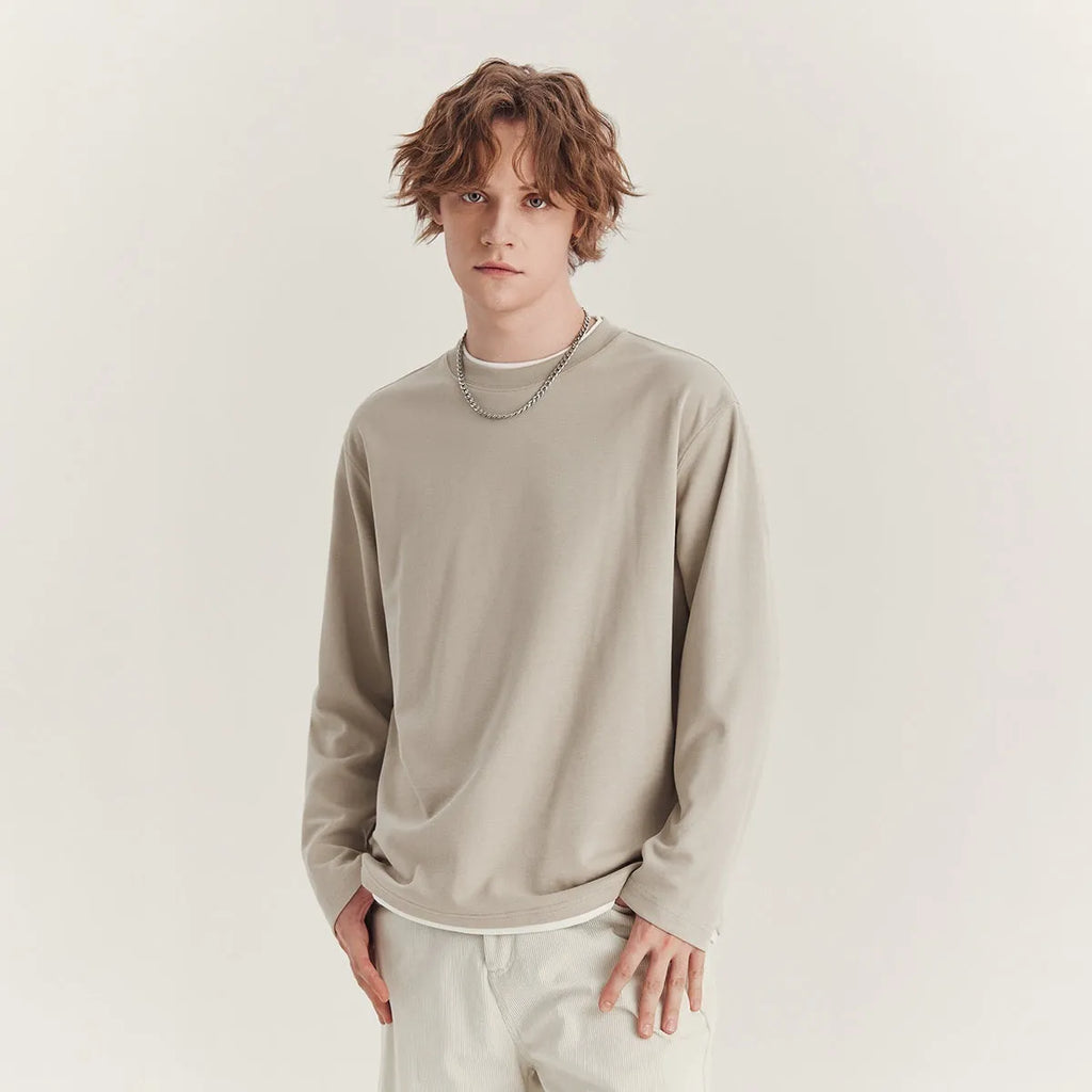 Men's loose fit long-sleeved cotton blend t-shirt in black, shown on a model.