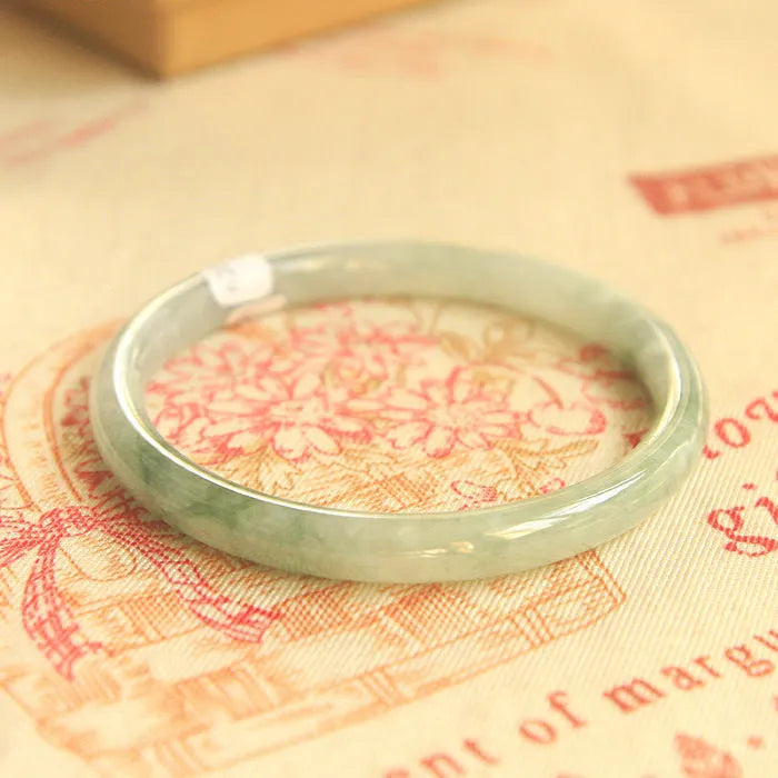 Green jade waxy Chinese style bracelet with geometric pattern showing 10mm width and adjustable sizing