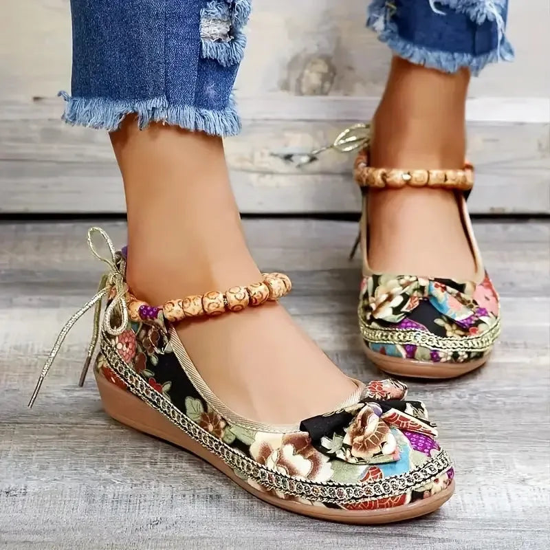 Women's black plus-size ethnic platform sandals with cloth upper and elastic band strap.