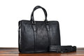 Men's brown leather retro style horizontal handbag with zipper, shown next to a 14-inch laptop for scale.